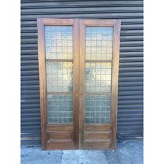 two wooden doors with glass panels on them