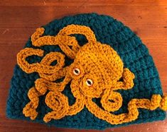 an octopus crocheted hat on a wooden table