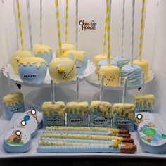 a table topped with cakes and desserts covered in frosting