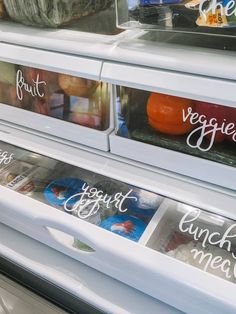 an assortment of veggies on display in a grocery store's refrigerator door