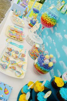 a table filled with lots of candy and cupcakes