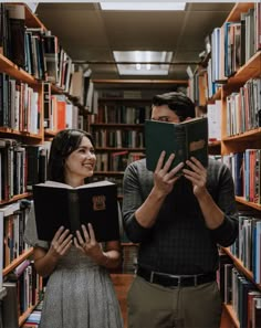 two people standing in front of bookshelves and looking at each other's faces