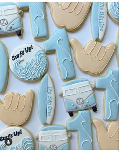 decorated cookies are arranged in the shape of buses and surfboards