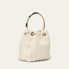 Jimmy Choo "Bon Bon" bucket bag in allover pearly satin viscose, brass, and ABS Flat metal top handle  Drawstring closure  Approx. 5.9"h x 5.5"W x 3.7"D Item Weight (Lbs.): 1.0 Made in Italy Luxury Party Bucket Bag With Gold-tone Hardware, Evening Handheld Bucket Bag With Gold-tone Hardware, Elegant Bucket Evening Bag With Gold-tone Hardware, Gold Bucket Bag With Detachable Handle For Evening, Elegant Gold Bucket Bag With Detachable Handle, Elegant Gold Bucket Bag For Evening, Elegant Bucket Bag For Party, Elegant Party Bucket Bag With Gold-tone Hardware, Luxury Bucket Bag For Party