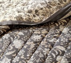 the comforter is made up with black and white floral designs on it's sides