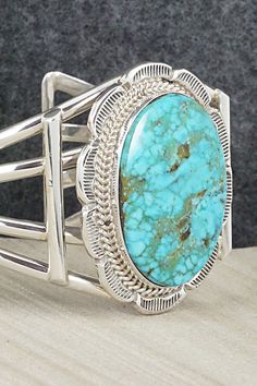 This Kingman turquoise and sterling silver bracelet was made by Navajo silversmith Raymond Delgarito. The inside is signed RD and stamped sterling.Size: 5 1/2" (will fit up to a 6 1/2" wrist)Gap: 1"Width: 1 3/4"Free shipping on all orders! We ship with USPS and always include tracking. All orders ship within a day of payment.Returns are accepted up to 30 days after you receive your order. Just send us a message. Our shop offers cash back or store credit. The item must be returned in new conditio Western Style Blue Sterling Silver Bracelet Gift, Southwestern Turquoise Sterling Silver Cuff Bracelet, Southwestern Style Turquoise Bracelet Stamped 925, Handmade Turquoise Sterling Silver Western Bracelet, Handmade Turquoise Sterling Silver Southwestern Bracelet, Southwestern Turquoise Cuff Bracelet Stamped 925, Turquoise Southwestern Cuff Bracelet Stamped 925, Handmade Southwestern Sterling Silver Bracelet, Southwestern Oval Sterling Silver Cuff Bracelet