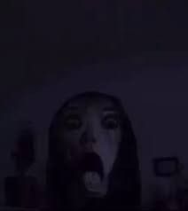 a woman with her mouth open in the dark