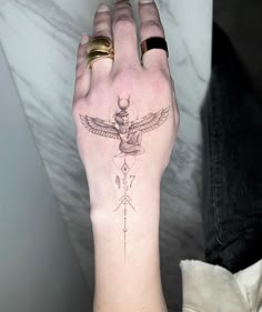 a woman's arm with a tattoo on it and a bird in the middle