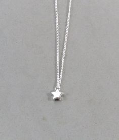 The star is silver plated and measures 9 mm It is strung on a silver plated tiny 1.3 mm curb chain with a lobster clasp closure. Choose the length from the drop down. Silver Dangle Charm Necklace With Star Charm, Silver Star Charm Necklace With Adjustable Chain, Silver Star Charm Necklaces, Silver Necklaces With Star Charm, Dainty Silver Star Charm Necklace, Minimalist Silver Star Charm Necklace, Silver Star Charm Necklace, Silver Star Necklace With Delicate Chain, Tiny Star Necklace