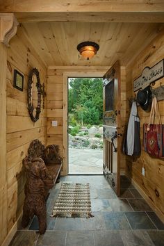 an entry way with wood walls and stone flooring