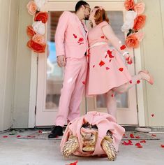 a man and woman dressed in pink standing next to each other