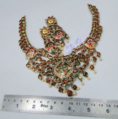 "20 carat solid gold, Old cut Diamonds and multicolor Enamel work necklace (Kundan Meena choker)with Matching Earrings. A large necklace Ideal for special occasions set with eye popping clear old cut genuine Diamonds. A solid piece of jewelry good for family Heirloom which will last for ever. Multicolor enamel at the back giving this piece a unique look of quality, great workmanship and great value for Money. Length of necklace -25 cm (9.84\") Size could be adjusted according to your requierment Multicolor Stone Work Temple Necklace For Ceremonial Occasions, Multicolor Temple Necklace With Stone Work For Ceremonial Occasions, Multicolor Temple Necklace For Festivals, 22k Gold Multicolor Chandbali Jewelry, Multicolor Hand Set Kundan Necklace For Ceremonial Occasions, Multicolor Kundan Necklace For Diwali With Intricate Design, Multicolor Chandbali Temple Necklace For Festivals, Multicolor Hand Set Temple Necklace For Festivals, Diwali Multicolor Kundan Necklace With Intricate Design