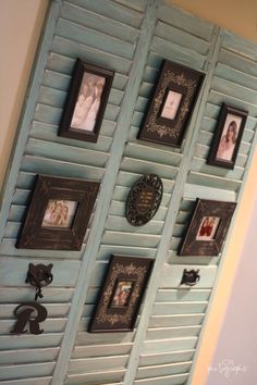 the wall is decorated with many pictures and framed photos, including frames on shutters