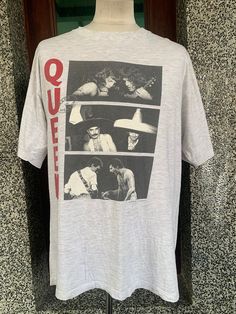 the rolling stones t - shirt on display in front of a wall with an image of them