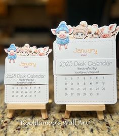 two desk calendars with little pigs on them