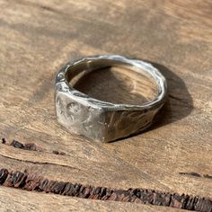 a silver ring sitting on top of a wooden table