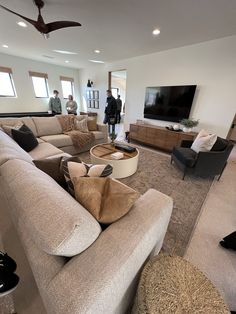 a living room filled with furniture and a flat screen tv on top of a wall