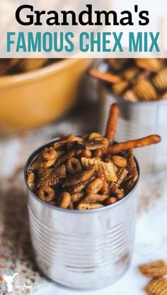 two tin cans filled with crackers and pretzels