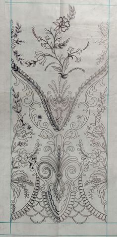 an intricately designed piece of paper with flowers and vines on it, as well as lines