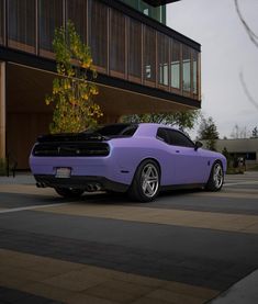 a purple car parked in front of a building