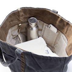 This take-anywhere travel set is crafted from a durable canvas that has been specially cured with a wax coating to age beautifully over time. Like high-quality leather, the waxed canvas looks and feels better the more you use it, and scratches and scuffs only add to its personality. Perfect for daily commuting or weekends away, the open tote features a hanging interior pocket to keep your essentials organized and the pouch features a water-resistant nylon lining. Add an embroidered monogram to t Travel Tech Organizer, Waxed Canvas Tote Bag, Tote Design, Oversized Tote Bag, Embroidered Monogram, Gifts For Colleagues, Travel Set, Aging Beautifully, Branded Gifts