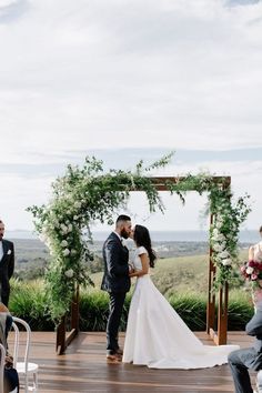 a bride and groom kissing at their wedding ceremony