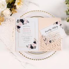 the wedding stationery is laid out on a plate