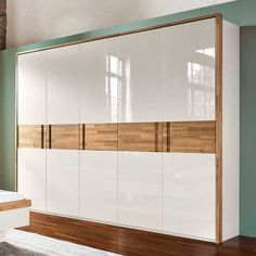 a large white and wood cabinet in a room