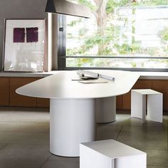 a white table and two stools in a room