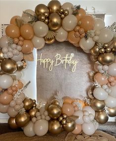 a happy birthday balloon wreath with gold and white balloons