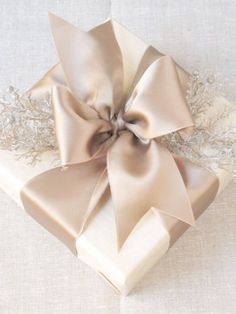 a gift wrapped in brown paper with a bow