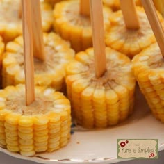 corn on the cob with wooden skewers sticking out of it's middle