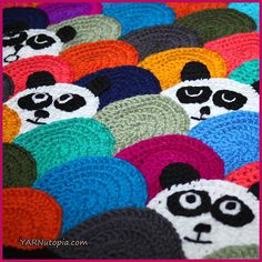 crocheted panda bears with different colors and sizes are shown on a blanket that has been made to look like they have eyes