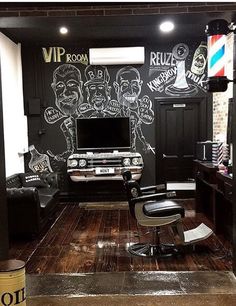 a barber shop with black walls and chalk drawings on the wall