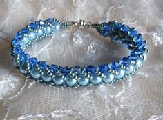 "The sophisticated color of blue combine with an accent color of light blue pearl makes the bracelet with a daintiness of the sky. This bracelet is hand stitch using Czech glass pearls, swarovski crystal and Japanese seed beads. It is finished off with a silver tone magnetic clasp for an easy wear. The bracelet measures 7 1/4\" and will fit 6 1/2\" to 7\" wrist comfortably and if you prefer this in different LENGTH and COLOR, custom work are welcome just convo me and it will be ship the next day Handmade Elegant Blue Pearl Bracelet, Elegant Handmade Light Blue Beaded Bracelets, Elegant Handmade Blue Pearl Bracelet, Blue Pearl Bracelets For Jewelry Making, Elegant Blue Beaded Crystal Bracelet, Elegant Blue Round Pearl Bracelet, Elegant Blue Pearl Bracelet, Blue Pearl Bracelet Gift, Blue Jubilee Crystal Bracelet With Round Beads