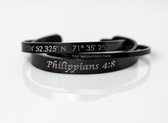 two black rubber bracelets with the words, you're trying to find what they are