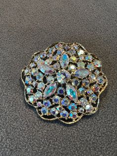 I am offering you this antique vintage Gorgeous yellow gold tone pin brooch. This features several combination prong set round and marquise aurora borealis colored shaped glass rhinestones that are all tightly set, and spectacular ! These stones are all set in a detailed raised relief dimensional curved cluster large round shaped setting. It is measuring app.  2.25  inches in diameter. Vintage Rhinestone Jewelry, Rhinestone Jewelry, Vintage Rhinestone, Vintage Yellow, Aurora Borealis, Pin Brooch, Jewelry Designs, Antique Vintage, Boho Jewelry