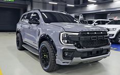 a white truck parked in a garage next to other cars