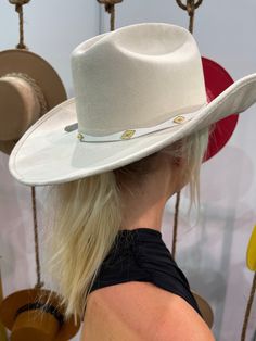 A fabulous and on trend cowboy hat that’s embellished with our exclusive crystal band around the crown. Meet the Shania Cowboy Hat! The best part? It's adjustable with an inner tie so it will fit most EVERYONE. THE HAT:-Cowboy style hat-Crystal trim around the crown-- OMG YES-Gorgeous color-Holds it's shape amazingly White Western Felt Hat For Kentucky Derby, White Western Fedora For Kentucky Derby, White Brimmed Hat Bands For Rodeo, Cream Hat Bands With Curved Brim For Rodeo, Country Style White Hat Bands For Kentucky Derby, White Flat Brim Fedora For Western-themed Events, White Western Felt Hat For Rodeo, White Western Style Felt Hat For Rodeo, White Western Felt Hat For Country Events