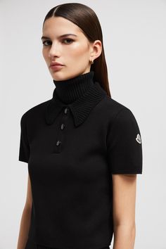 This polo shirt is crafted from extra-fine Merino wool for unparalleled softness. The design boasts a delicate knit collar, playing with textures to infuse the style with a feminine feel. Luxury Black Wool Top, Elegant Short Sleeve Polo Sweater With Ribbed Collar, Luxury Collared Winter Tops, Luxury Collared Tops For Winter, Fitted Polo Sweater With Seamless Collar, Elegant Fitted Polo Sweater With Collared Neckline, Luxury Tops With Polo Ribbed Collar, Luxury Wool Tops With Ribbed Collar, Winter Polo Sweater With Collared Neckline