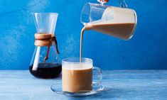 coffee being poured into a glass mug