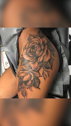 a woman's arm with a rose tattoo on it