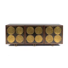 an art deco sideboard with gold circles on it