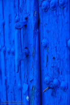 blue painted wooden doors with handles and knobs