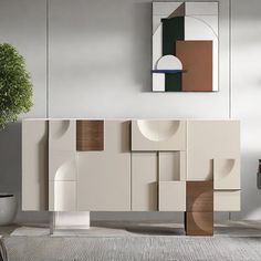 a modern sideboard with geometric shapes in an empty living room, next to a potted plant