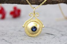 shop for Amazing gold and a blue sapphire pendant necklace in 14k, 18k OR 22k solid yellow, white or rose gold, in a boho antique style design. This gold boho necklace is stunning and unique. It has a decorated antique style domed disc pendant set with a blue sapphire. Bohemian Yellow Gold Round Pendant Necklace, Gold Sapphire Jewelry Stamped 14k, Gold Sapphire Necklaces For Gift, Gold Sapphire Necklace For Gift, Gold Sapphire Necklace For Gifting, Gold Sapphire Gemstone Necklace, Gold Sapphire Necklace Hallmarked, Gold Sapphire Round Pendant Jewelry, Gold Sapphire Round Pendant Necklace