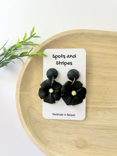 #Ballarat locals- Enter code LOCALSHOPPER at checkout for FREE DELIVERY# These earrings are made locally in Ballarat from polymer clay and have stainless steel posts for sensitive ears. Each set of earrings are lovingly created, however being a unique handmade product there may be slight differences in the patterns from the images shown or slight imperfections in the clay. -POSTAGE- Items are sent in a padded mailer bag unless an alternative shipping option is selected. # Please allow for current mailing delays due to COVID-19, I do not have control over delivery times once the item is in the hands of Australia Post. -EARRING CARE- - Polymer clay earrings are strong but can still break, please treat carefully. - Wipe clean with cloth - Keep clear of direct heat or prolonged periods in sunl Flower Dangle Earrings, Black Flower, Sensitive Ears, Handmade Jewellery, Unique Earrings, Polymer Clay Earrings, Clay Earrings, Cleaning Wipes, Jewelry Earrings Dangle