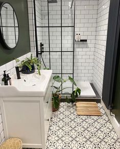 the bathroom is decorated in black and white tile, with an interesting pattern on the floor