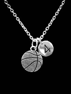 a silver necklace with a basketball charm and a number 4 on the ball hanging from it