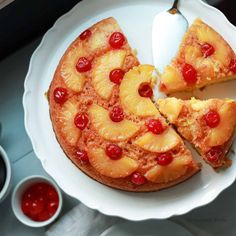 a pineapple upside down cake on a plate with a slice cut out and ready to be eaten